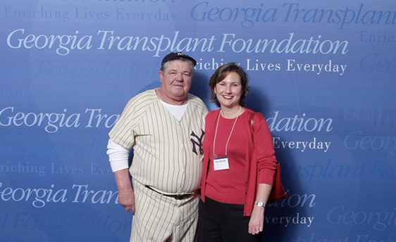 Blue Portable Display Behind Two Smiling Adults