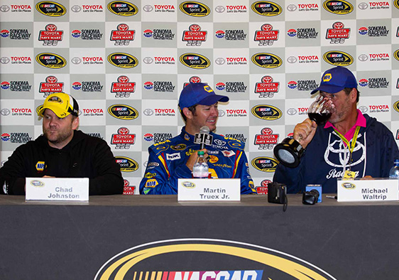 Colorful Backdrop Behind NASCAR Racers